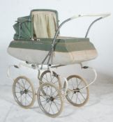 A vintage retro mid 20th Century Tri-ang made child's push along toy pram finished in pale green and