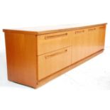 A vintage retro mid 20th Century Meredew teak wood sideboard having three cupboard doors beside a