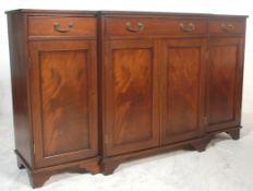 A 19th century Regency revival flame mahogany breakfront sideboard being raised on bracket feet with