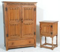 An early 20th century Jacobean revival carved oak bachelors wardrobe and matching bedside put