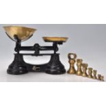 A set of early 20th Century Librasco balance scales having an ebonised metal body with brass bowls