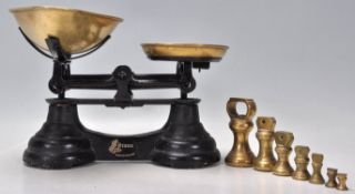 A set of early 20th Century Librasco balance scales having an ebonised metal body with brass bowls