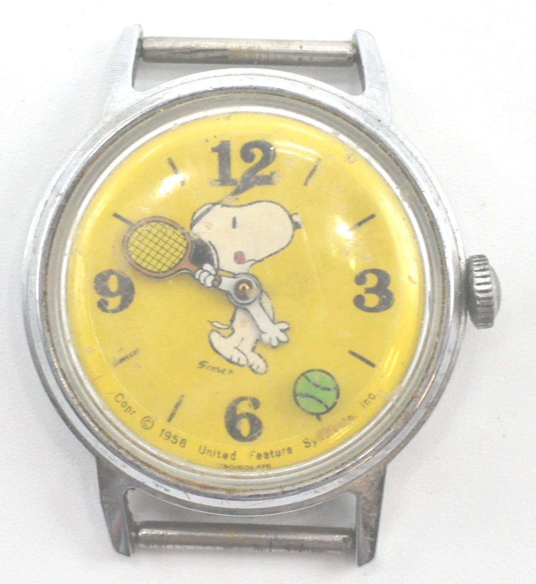 A rare 1958 Timex Snoopy wristwatch with yellow dial. The Timex movement in stainless steel case