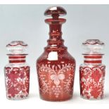 A group of early 20th Century antique bohemian ruby glass to include a bottle decanter having a