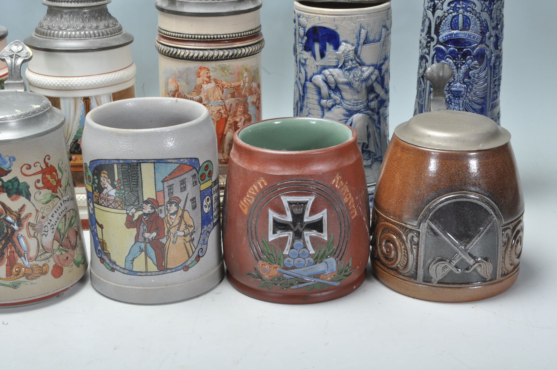 A collection of 20th Century German ceramic stein drinking glasses, many having raised blue and grey - Bild 7 aus 9