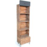A group of five converted storage crate shelf display / bookshelf unit raised on castors.