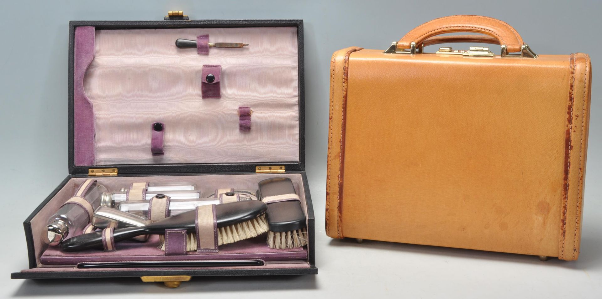 A 1930's vintage dressing table set having an ebony hair and clothes brush, a selection of glass