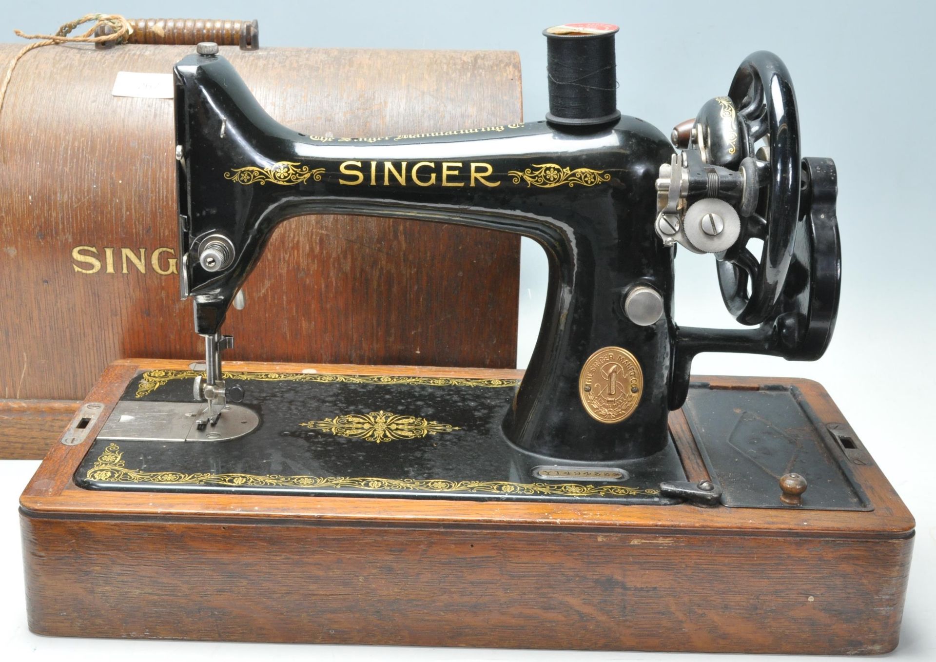 A 19th Century Victorian Singer sewing machine having an ebonised metal body set within a wooden - Image 2 of 5