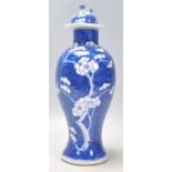 A late 19th Century Chinese blue and white baluster vase hand painted in the prunus pattern,