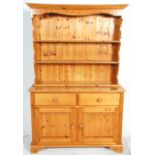 A 20th Century pine dresser, the base having twin drawers above twin cupboards with knob handles