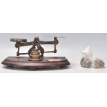 A set of 19th Century Victorian brass postal scales mounted on a rectangular mahogany base. The
