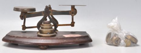 A set of 19th Century Victorian brass postal scales mounted on a rectangular mahogany base. The