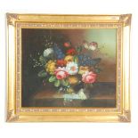 A vintage 20th century oil on canvas still life painting depicting a display of flowers within a