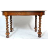 A good 1930's early 20th Century barleytwist oak dining table. The table having an oval top raised