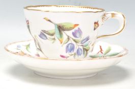 A 19th Century English Meissen style porcelain tea cup and saucer having hand painted floral