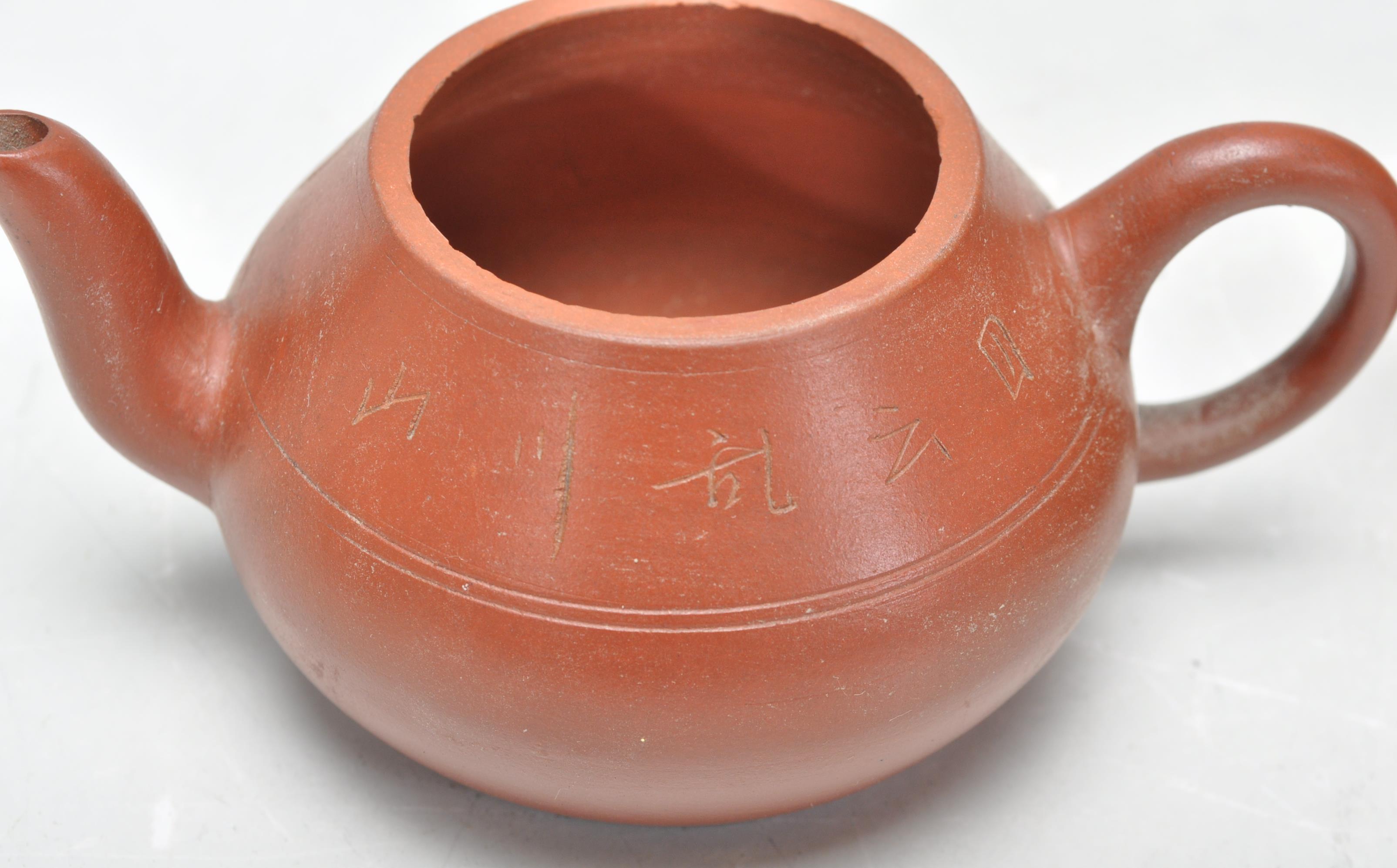 A collection of Chinese yixing teapots each of red clay terracotta form. To include a cylindrical - Image 9 of 12