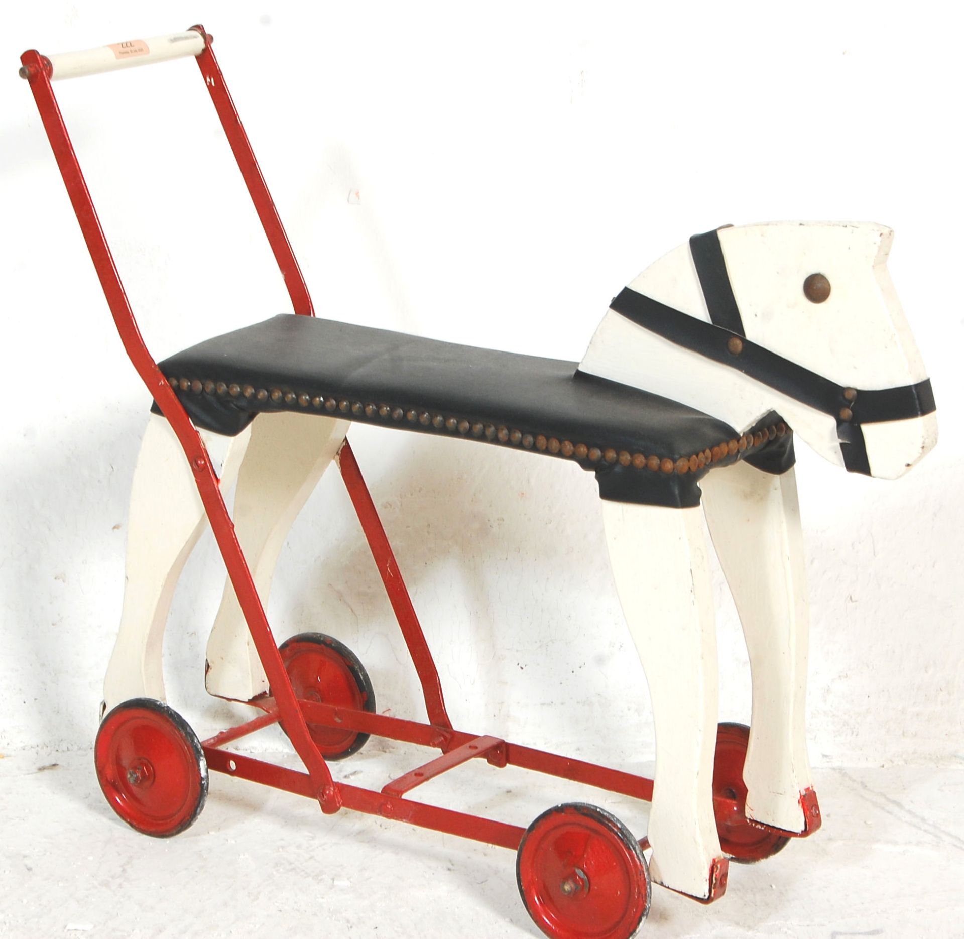 A vintage 20th Century push / ride along horse constructed form wood and metal finished in white and