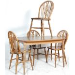 A set of four 20th Century wheel back dining chairs having rail backs with pierced wheel splats