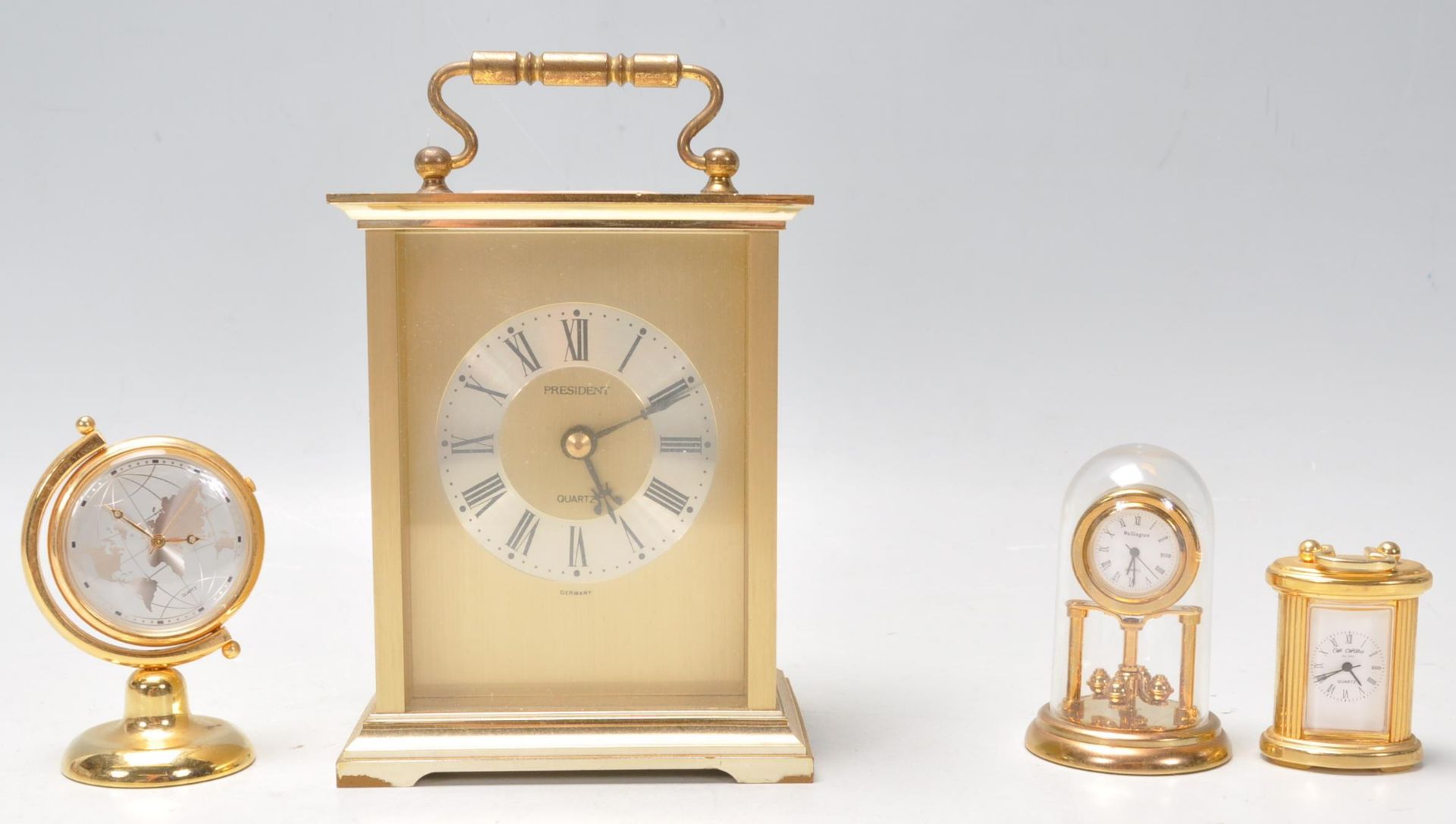 A vintage 20th Century brass cased carriage clock by President having gilt brushed design interior