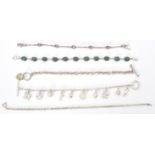 A collection of silver bracelets to include a charm bracelet, malachite cabochon set, pink stone