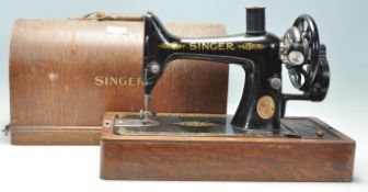 A 19th Century Victorian Singer sewing machine having an ebonised metal body set within a wooden