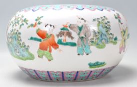 A 19th Century Chinese jardiniere / ginger jar of squat form with polychrome decoration featuring