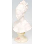 A 20th Century marble composite bust ornament in the form of a woman wearing an off the shoulder
