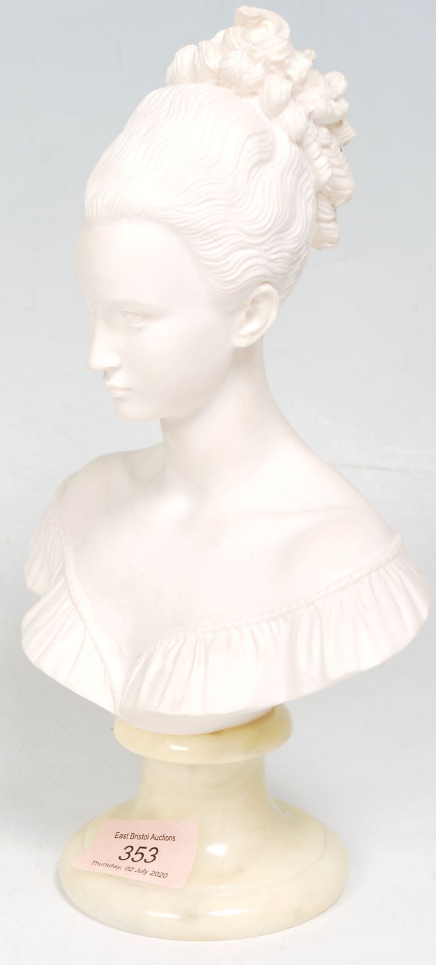 A 20th Century marble composite bust ornament in the form of a woman wearing an off the shoulder