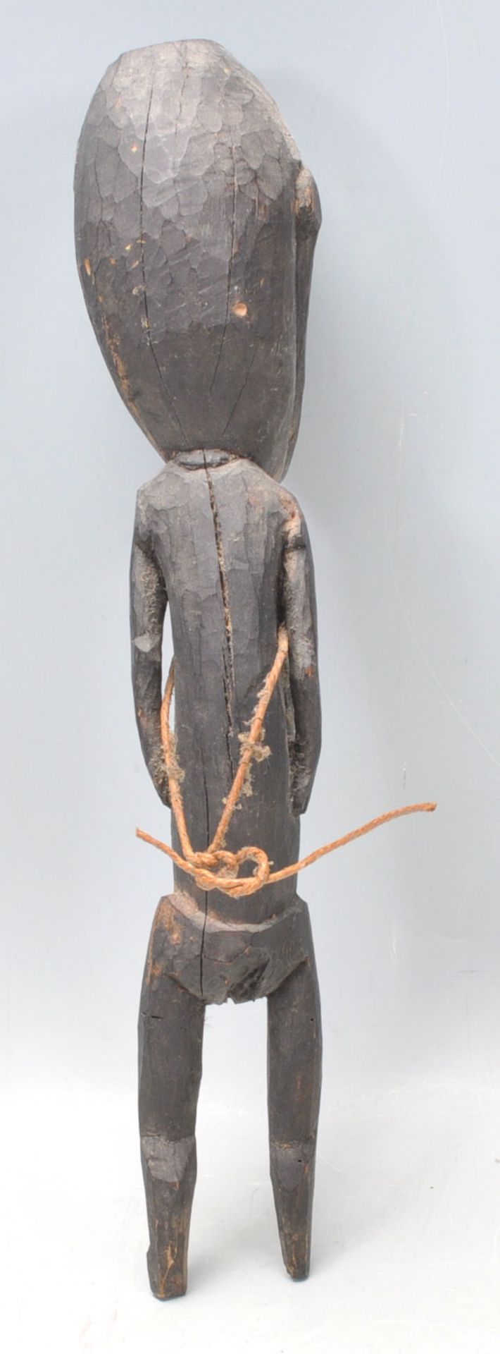 A carved tribal ebonised wooden figurine having an stylistically large head with short limbs - Bild 8 aus 9