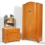 A 1930's Art Deco oak veneer bedroom suite. The suite comprising a wardrobe having domed door and