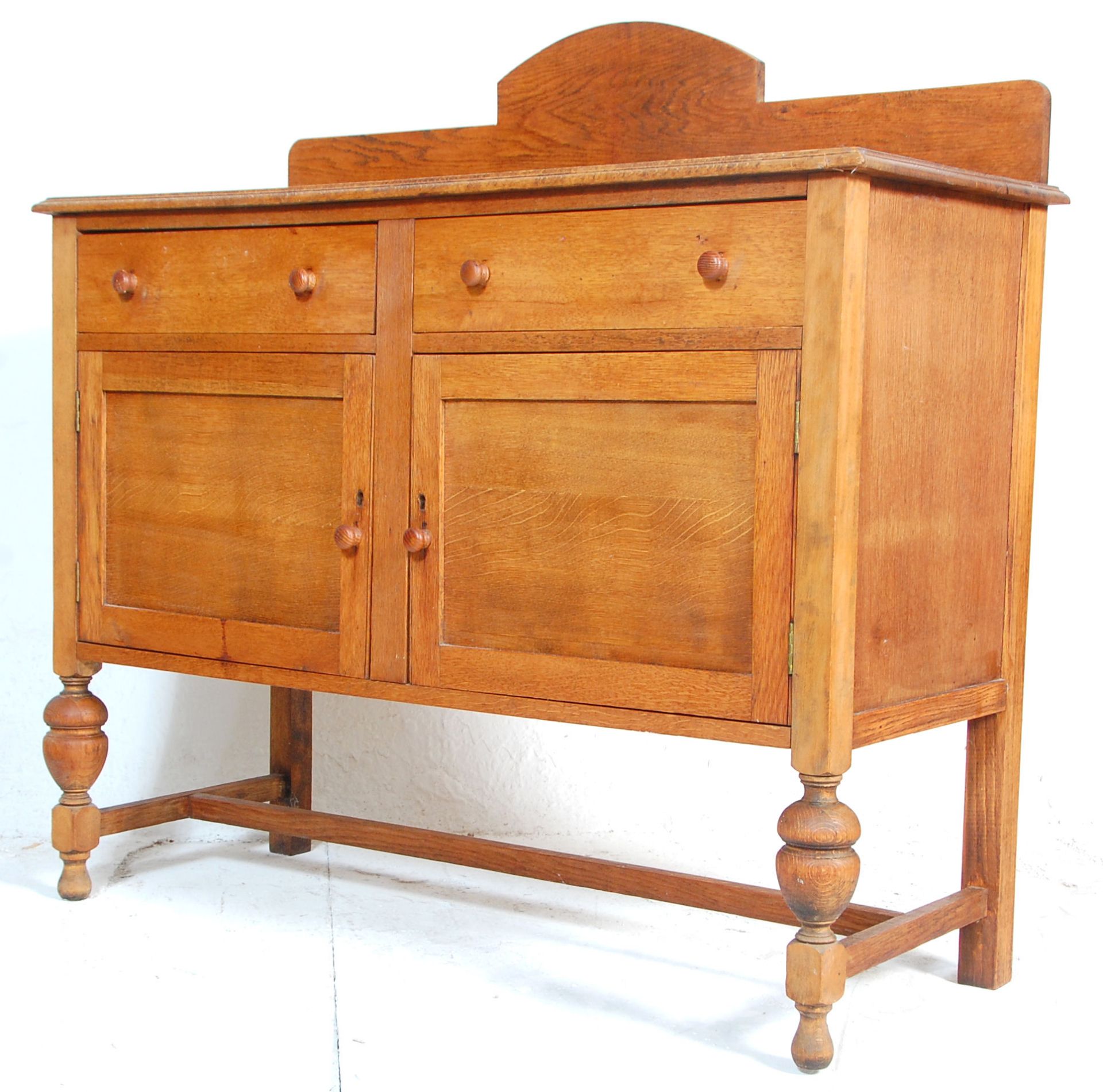 A 20th Century 1930's oak side cupboard / serving sideboard credenza having twin drawers above