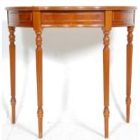 A 20th Century antique style mahogany demi lune side table having a serpentine front with single