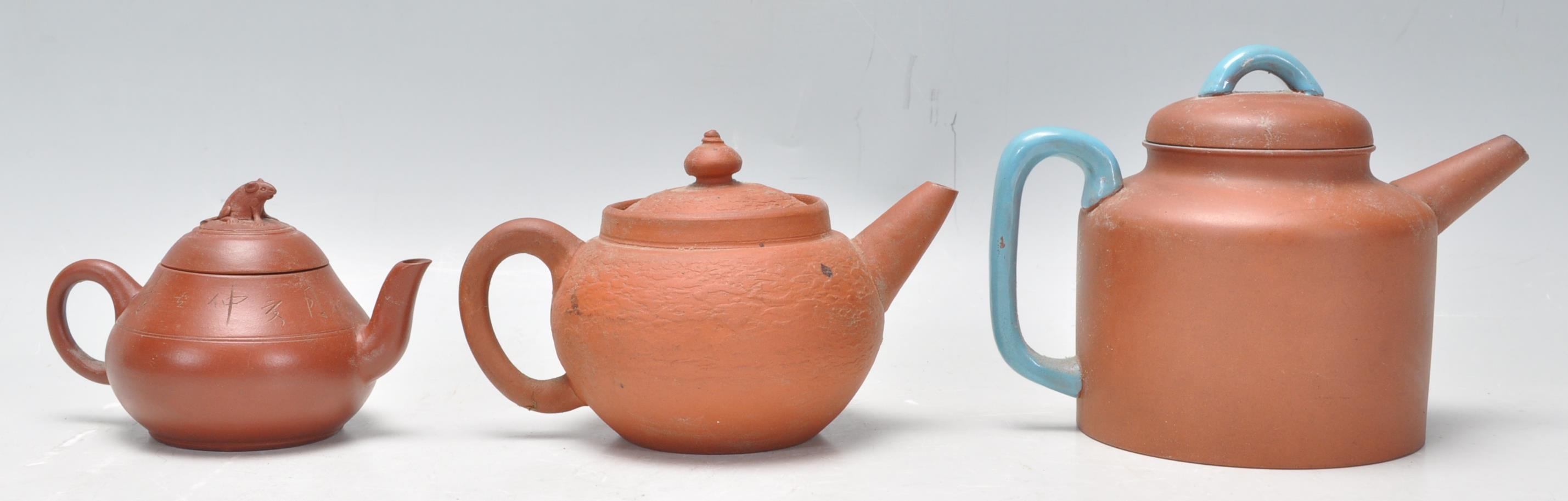 A collection of Chinese yixing teapots each of red clay terracotta form. To include a cylindrical - Image 3 of 12