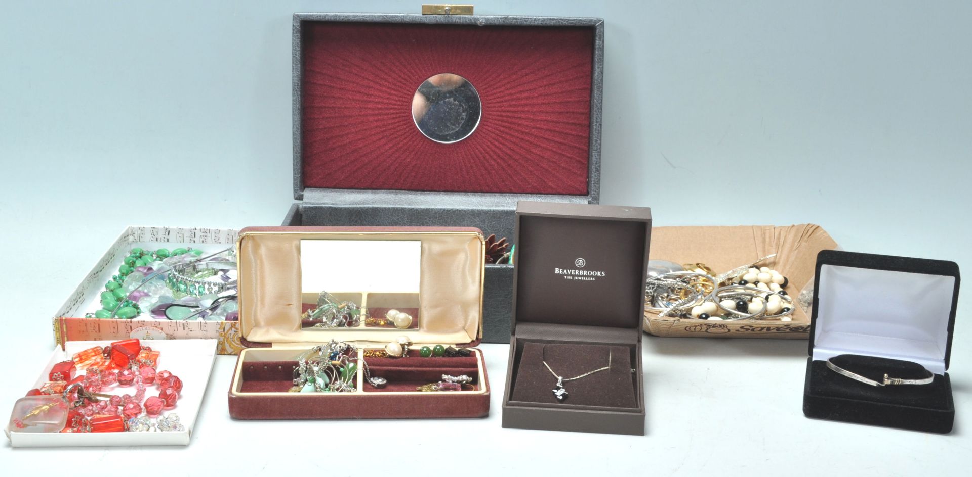 A collection of vintage costume jewellery across multiple jewellery boxes to include a wide