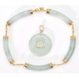 A 14ct yellow gold and jade Chinese  bracelet and necklace pendant suite. The doughnut shaped