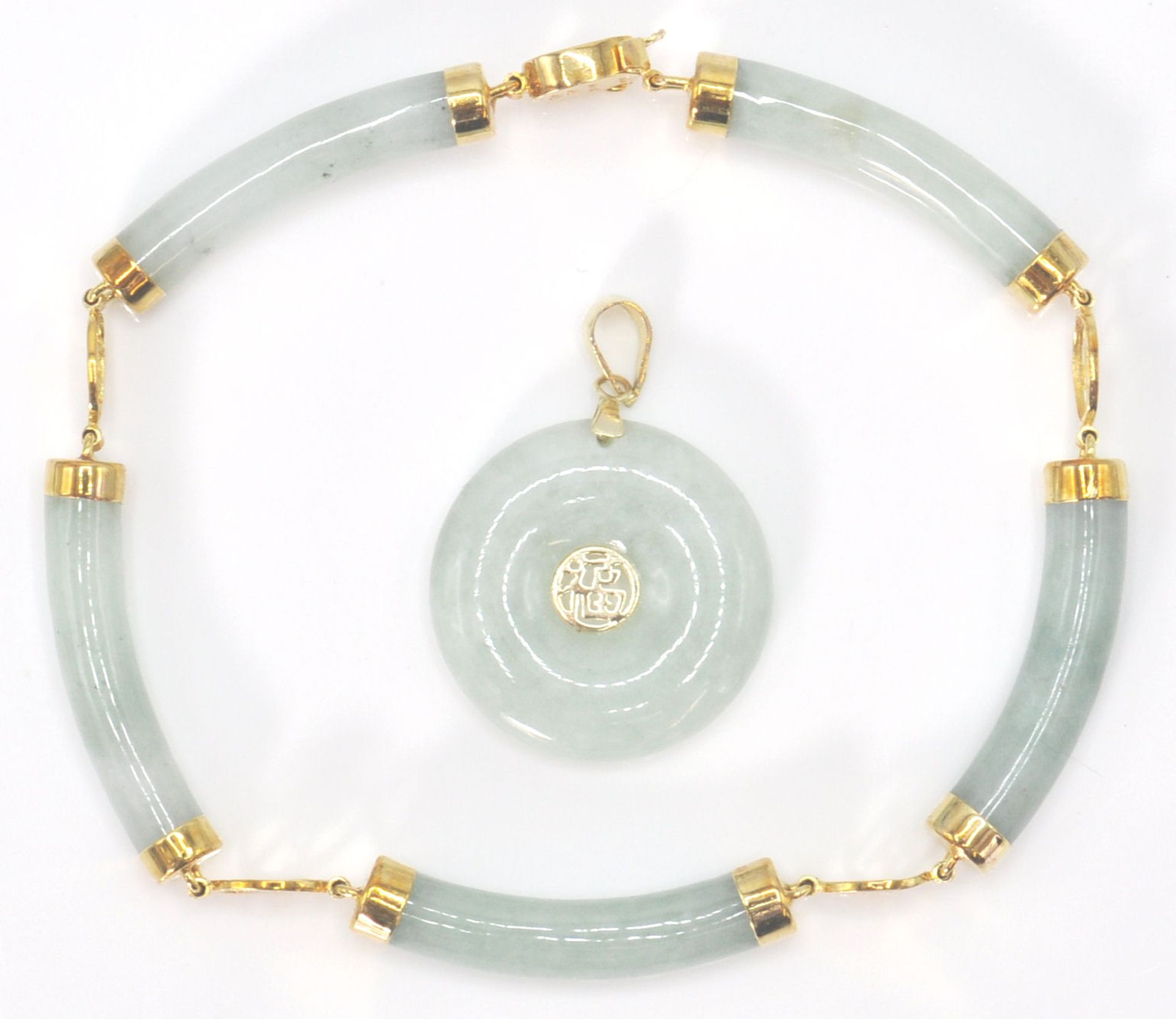 A 14ct yellow gold and jade Chinese  bracelet and necklace pendant suite. The doughnut shaped