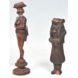 Two antique carved treen ware black forest decorative tools to include a corkscrew in the form of