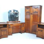 A good early 20th Century oak linen fold Jacobean revival bedroom suite comprising a dressing