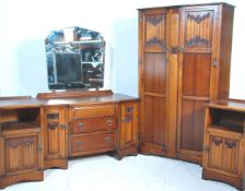 A good early 20th Century oak linen fold Jacobean revival bedroom suite comprising a dressing