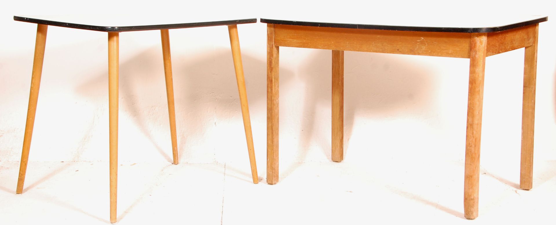 Two vintage retro mid 20th Century 1960's melamine topped tables each being raised on tapering beech