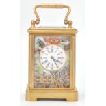 A vintage brass cased miniature carriage clock with porcelain panels decorated with roses, having