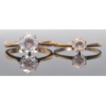 Two hallmarked 9ct gold and white stone solitaire rings, both set with round cut white stones in