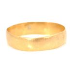 A hallmarked 22ct gold band ring of plain form. Ha