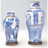 A 19th Century Chinese crackle glaze vase being hand painted in blue and white depicting two