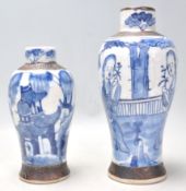 A 19th Century Chinese crackle glaze vase being hand painted in blue and white depicting two