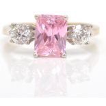 A 9ct gold hallmarked 3 stone ring. The ring with central pink CZ in prong setting flanked by cz