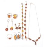 A collection of silver and amber set jewellery to include 3 amber cabochon set rings,  2 amber set