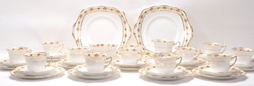 A Fine Bone China English tea service by Roslyn China having floral banded borders comprising twelve