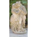 An early 20th Century reconstituted stone garden sculpture in the form of a couple in garden wearing