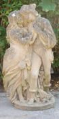 An early 20th Century reconstituted stone garden sculpture in the form of a couple in garden wearing